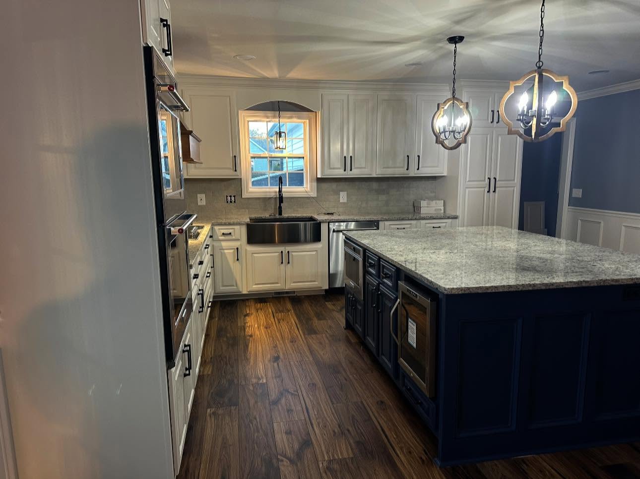 Kitchen after - white cabinets, navy island